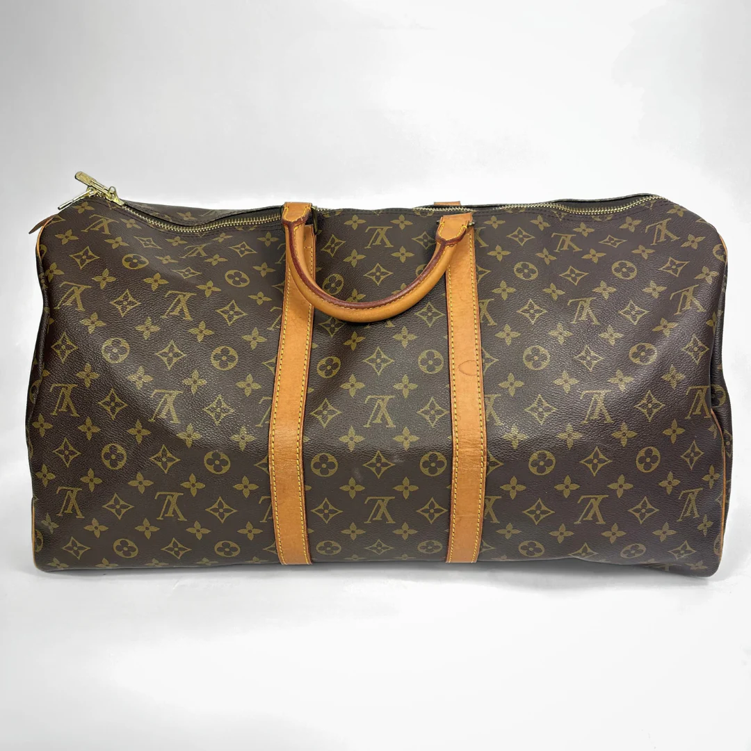 Brown travel bag with tan straps on a white background