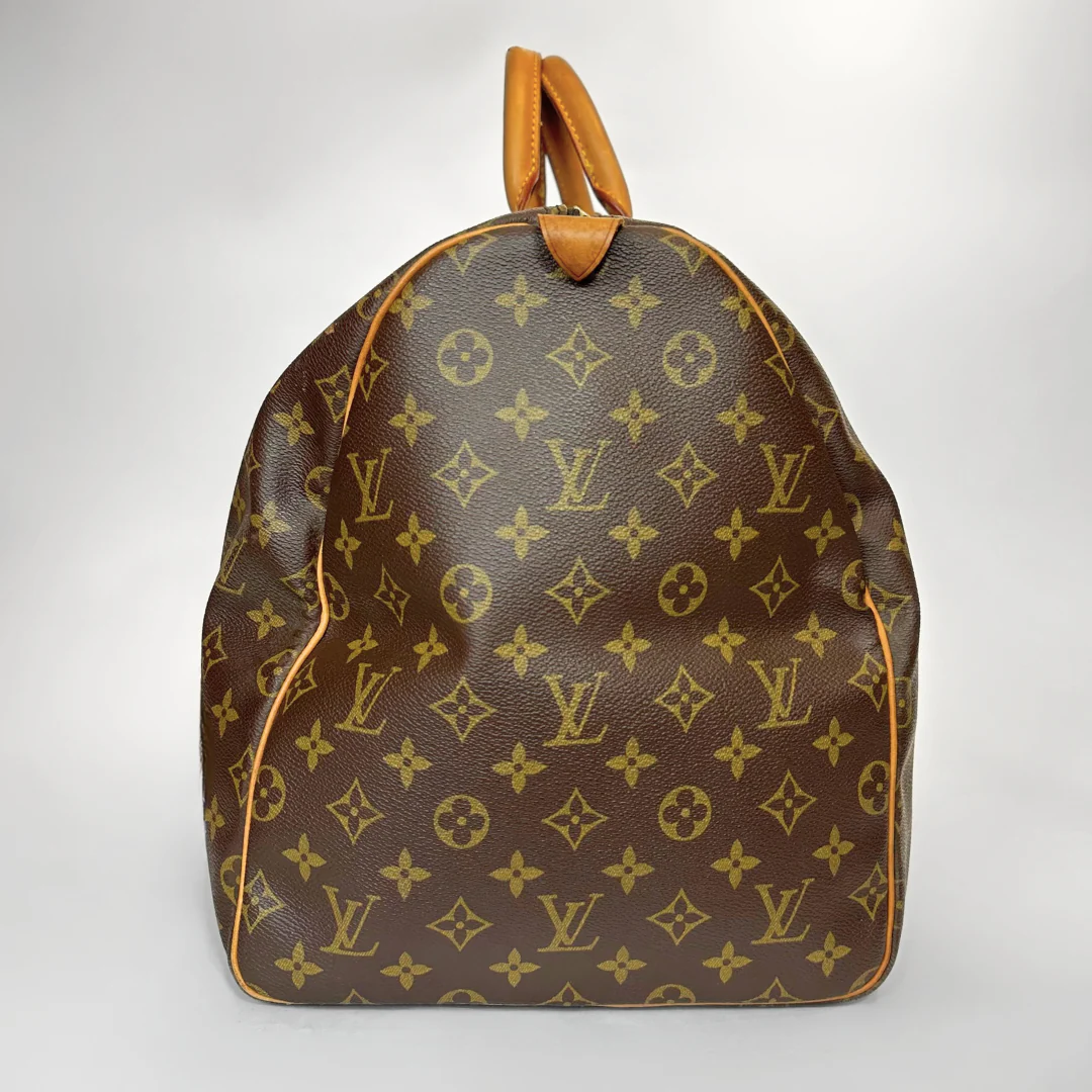 Brown backpack with yellow monogram pattern on a white background