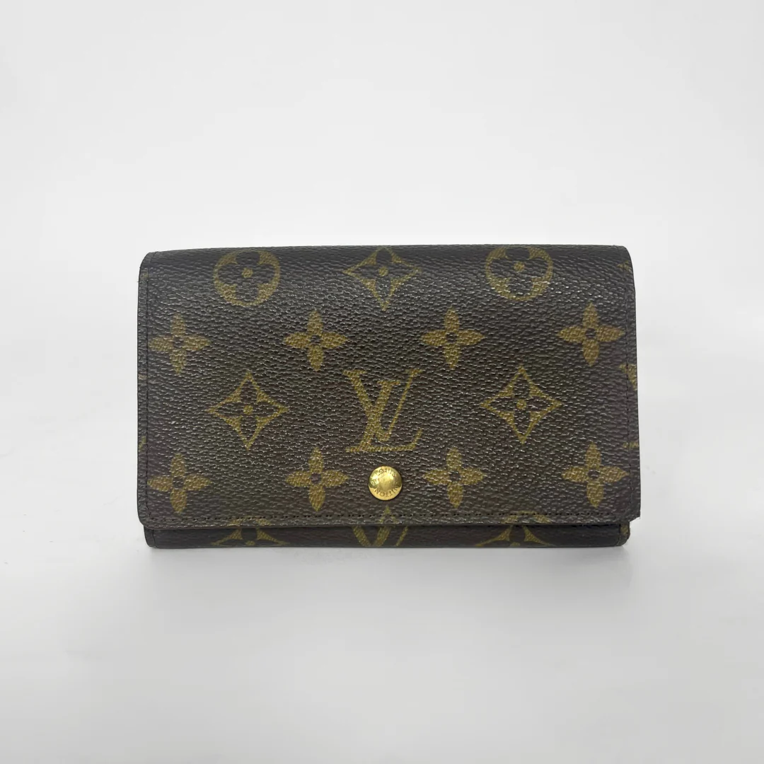 Louis Vuitton wallet with monogram pattern on a white background