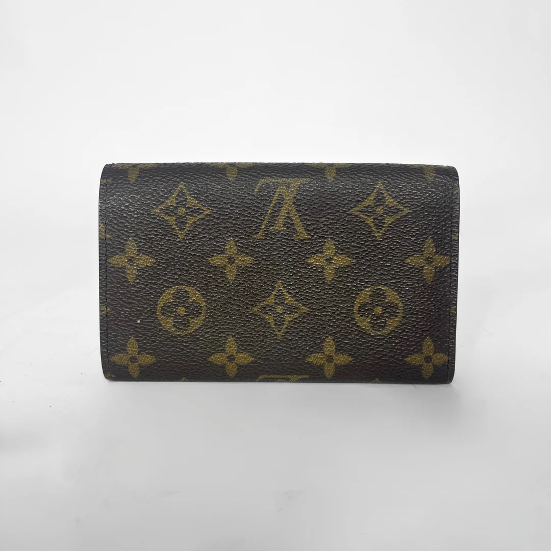 Folded wallet with brown leather interior on a white background