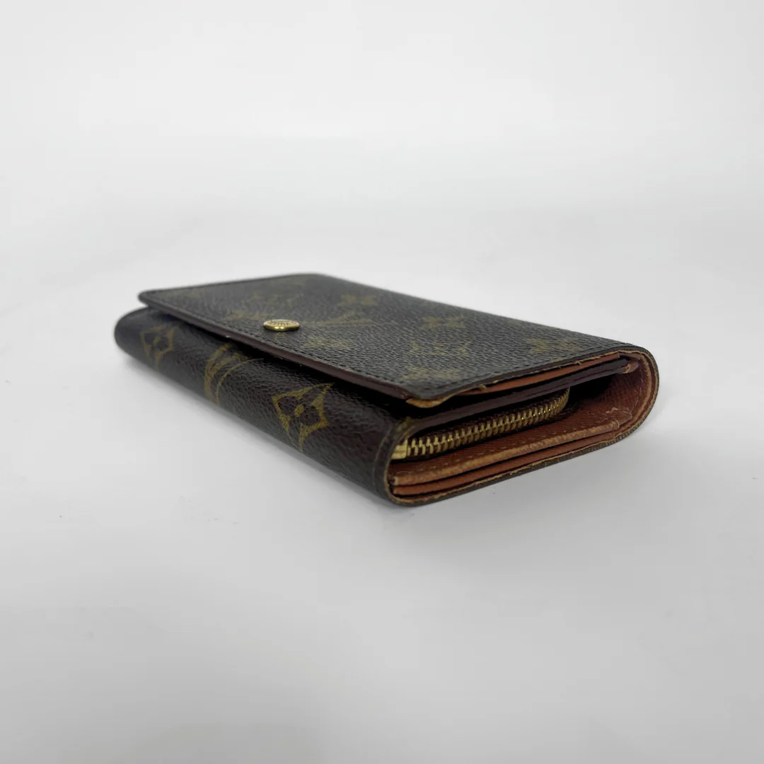 Folded wallet with brown leather interior on a white background