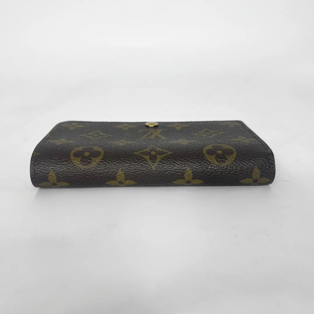 Folded wallet with brown leather interior on a white background