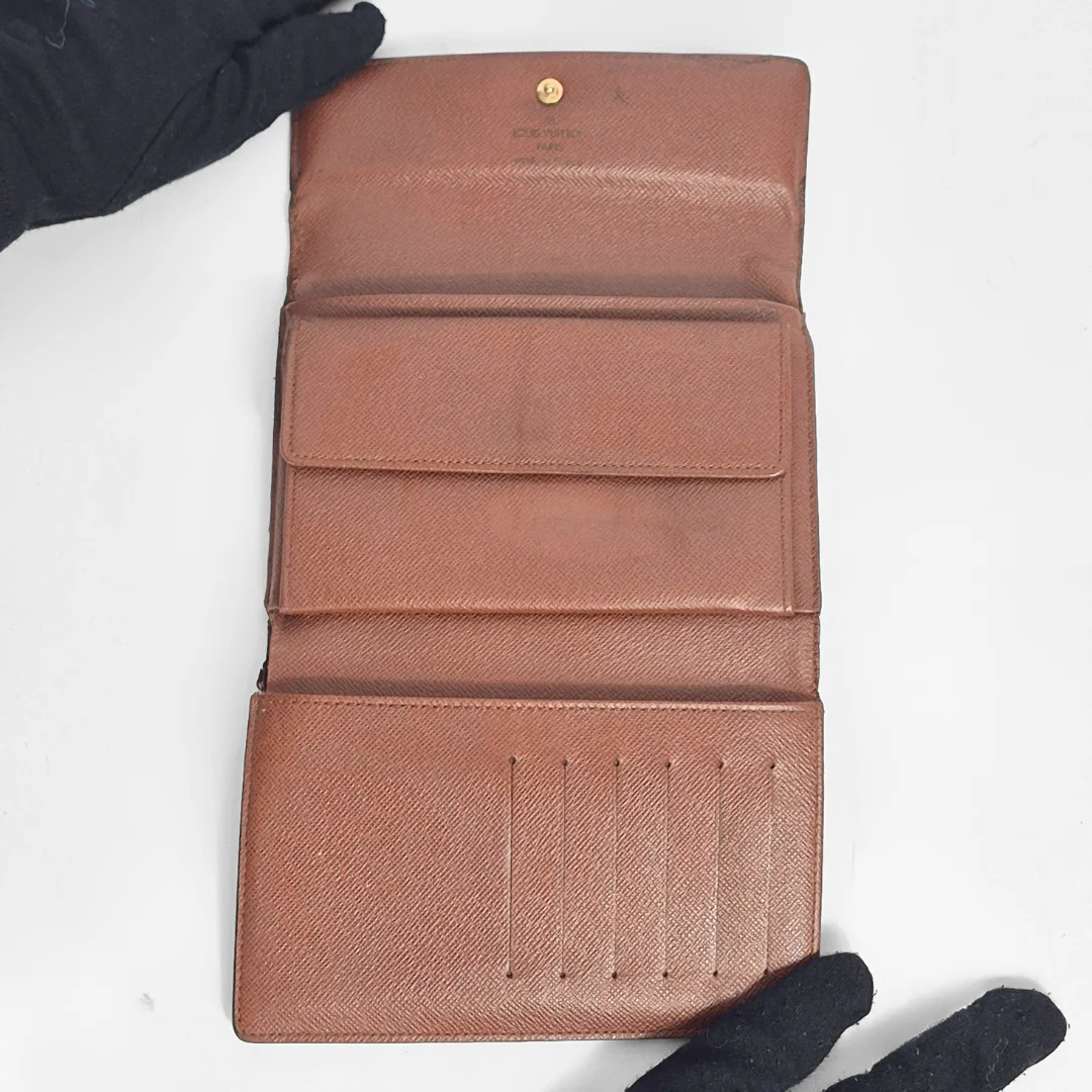 Brown wallet with visible brand logo on a white background