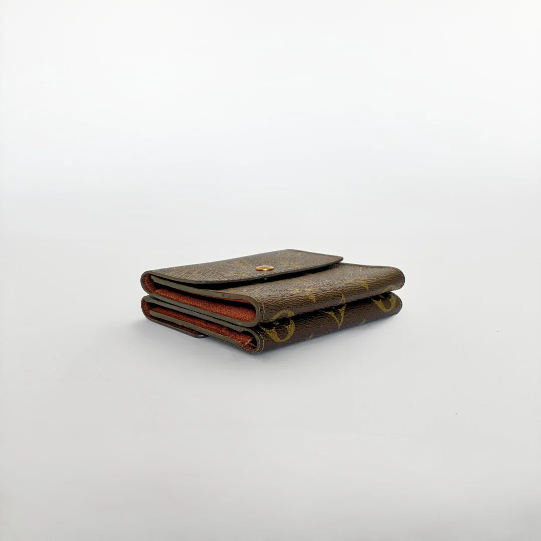 Louis Vuitton wallet with monogram pattern on a white background