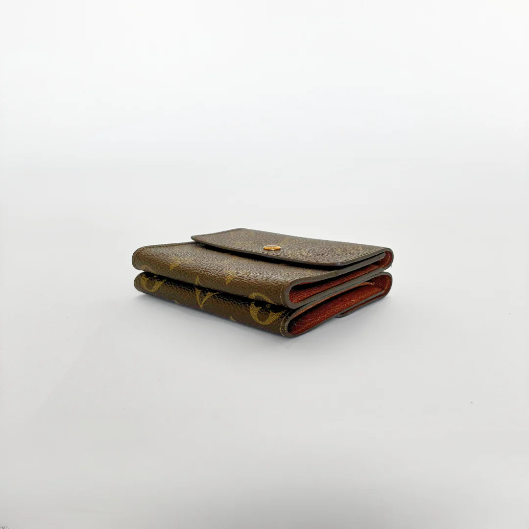 Louis Vuitton wallet with monogram pattern on a white background