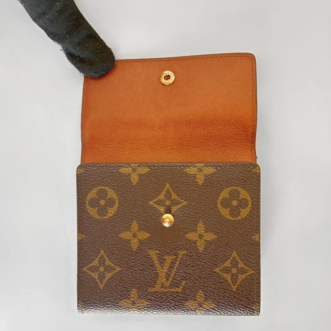 Louis Vuitton wallet with monogram pattern on a white background