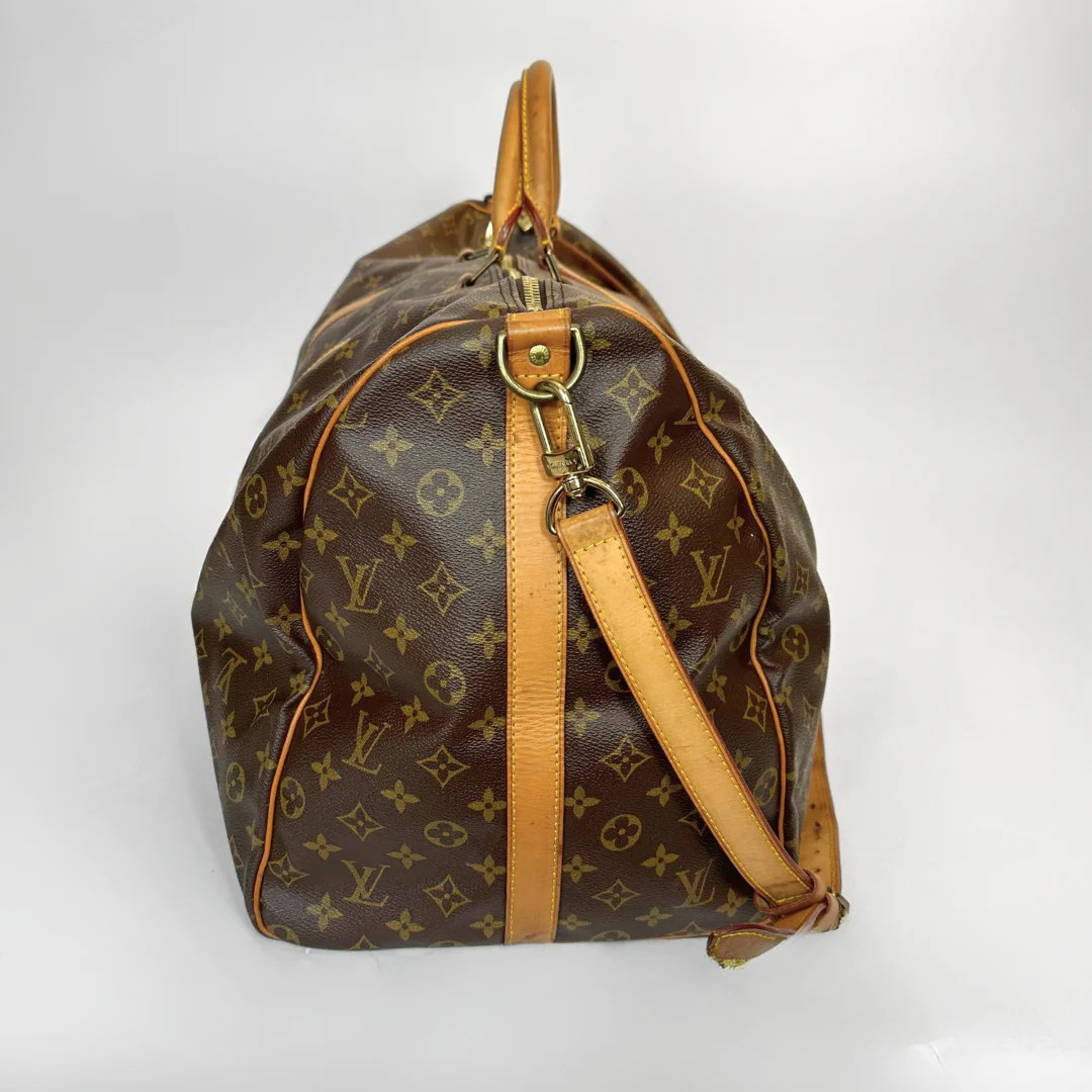 Brown monogram handbag with tan leather accents on a white background