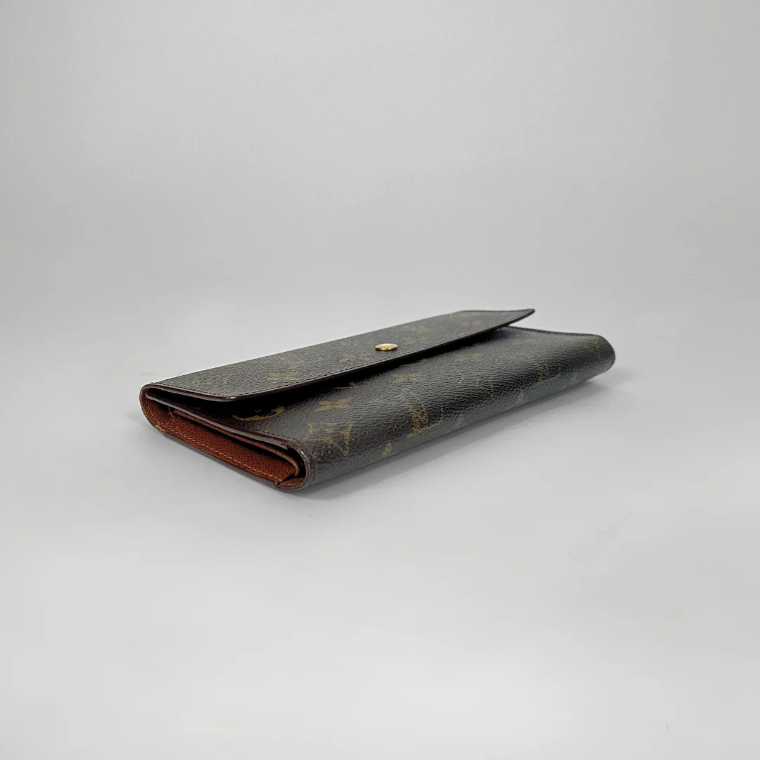 Louis Vuitton wallet on a light gray background