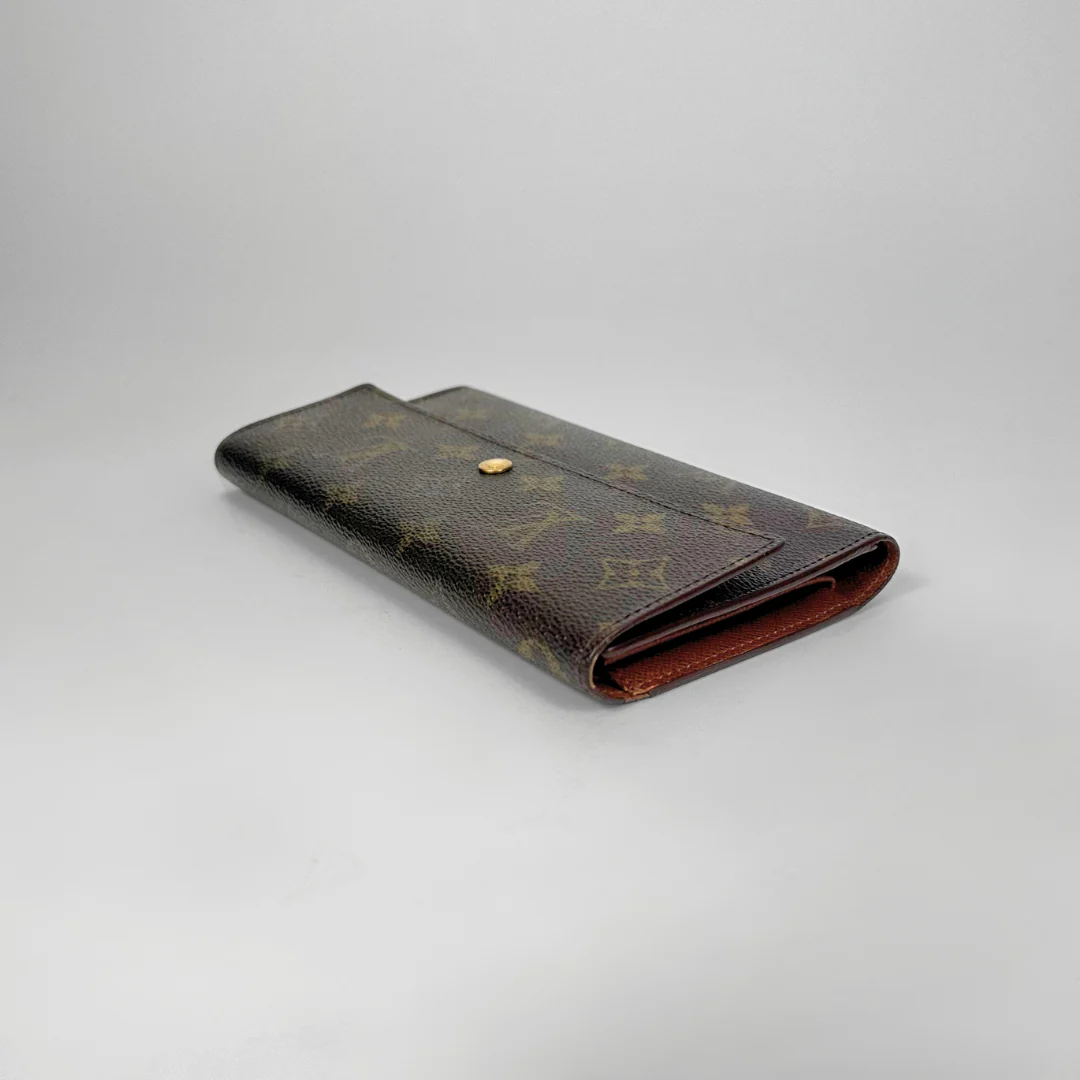 Brown wallet with pattern on a gray background