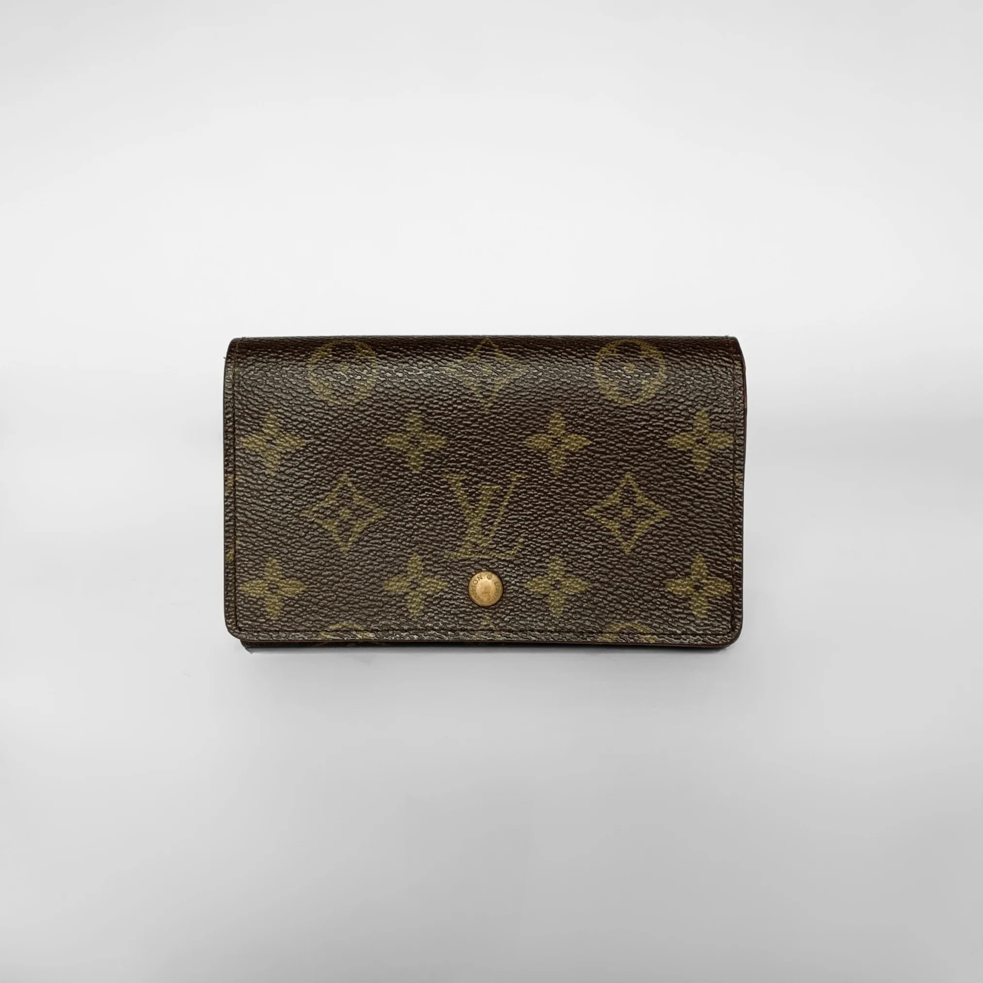 Louis Vuitton wallet with monogram pattern on a white background
