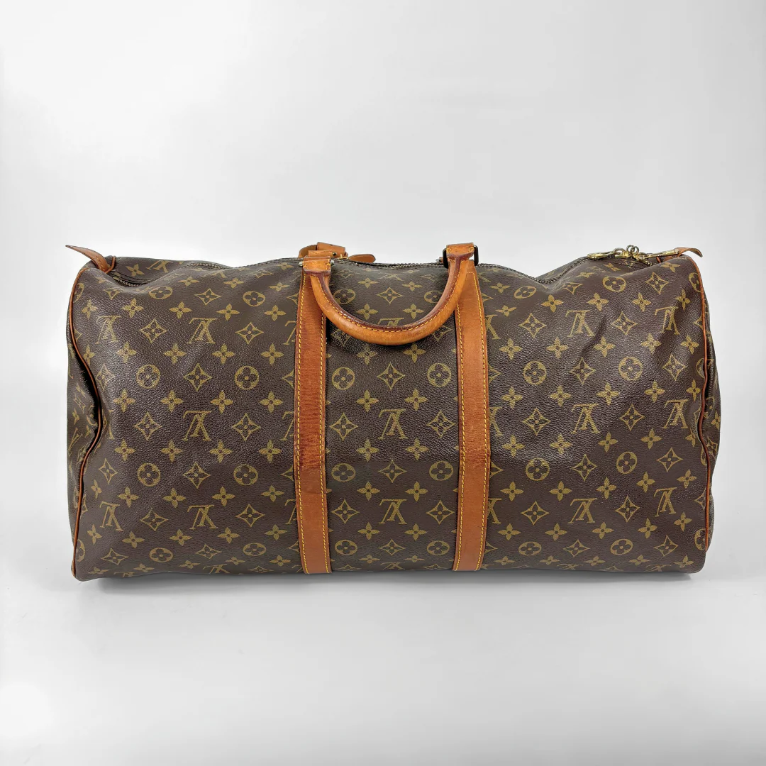 Brown Louis Vuitton travel bag with monogram pattern on a white background