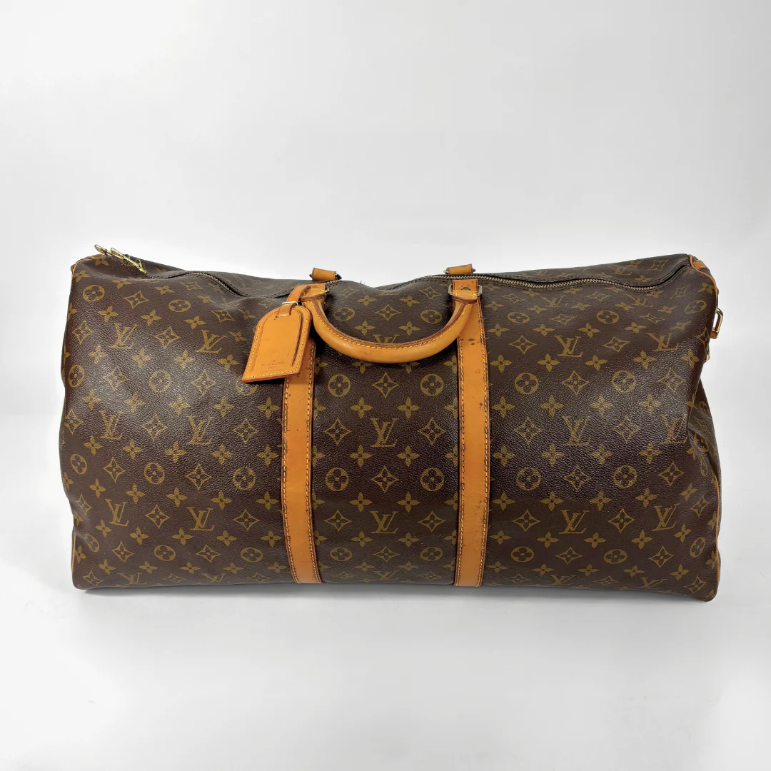 Brown Louis Vuitton travel bag with monogram pattern on a white background