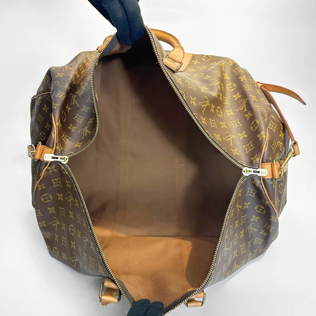 Brown monogram patterned bag with gold hardware on a white background