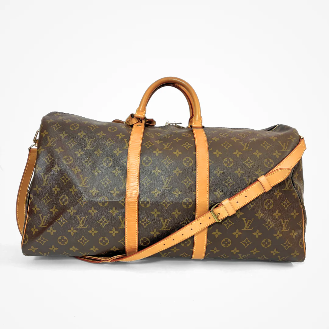 Brown LV duffel bag with monogram canvas and tan leather straps on a white background