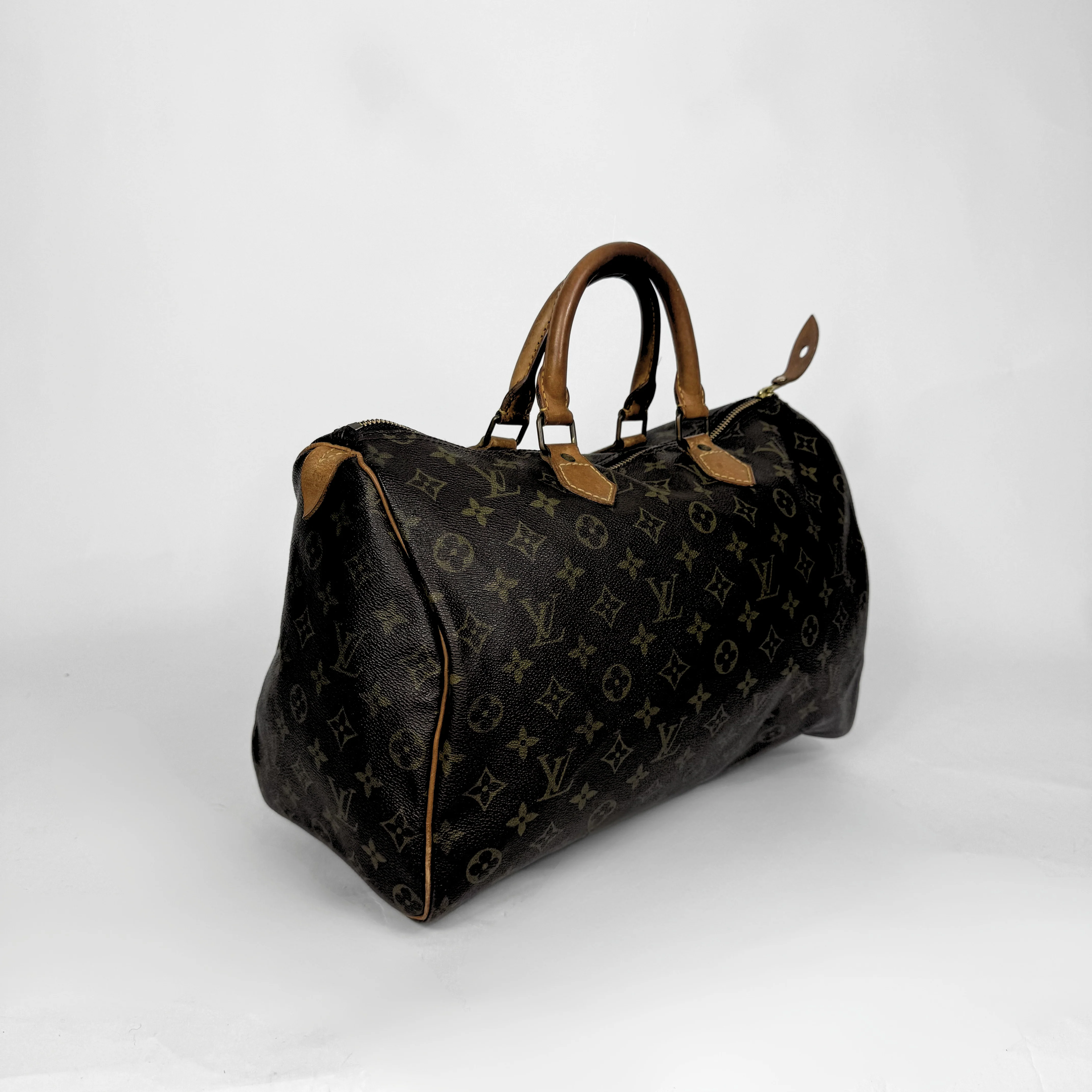 Designer handbag with monogram pattern on a white background