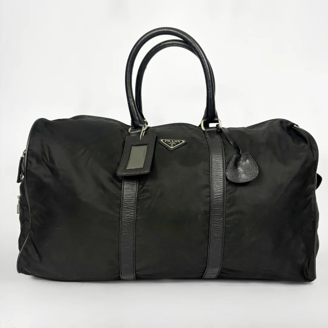 Black backpack with a strap and lock on a white background
