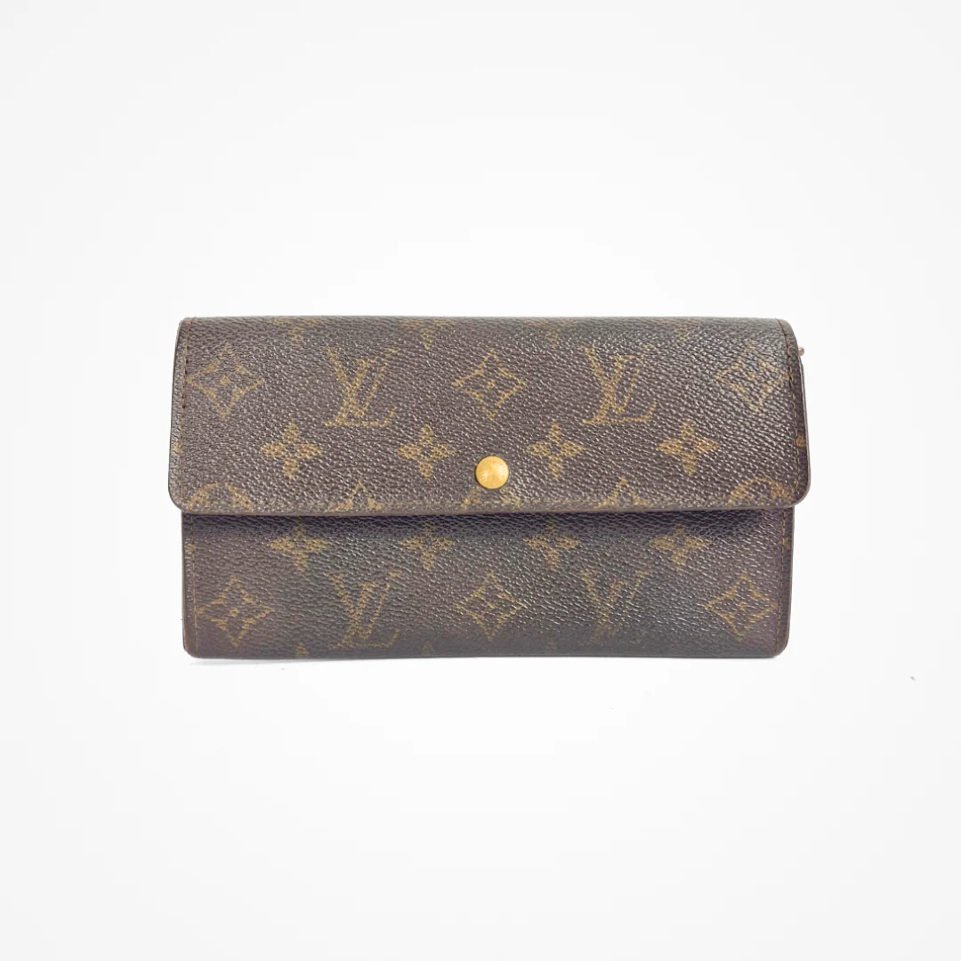 Brown LV wallet with gold monogram pattern on a white background