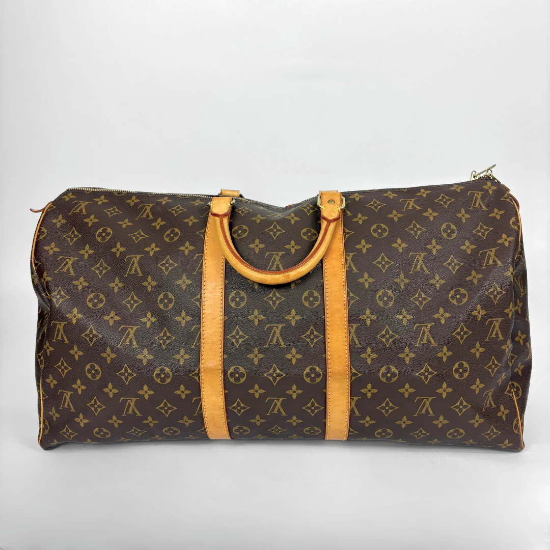 Brown travel bag with yellow handles on a white background