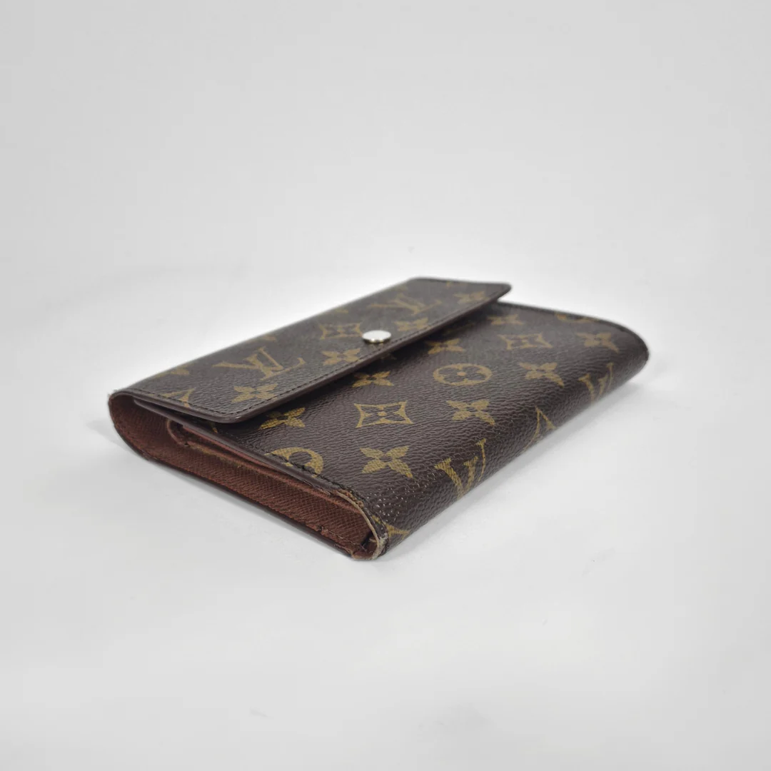Louis Vuitton wallet with monogram pattern on a white background