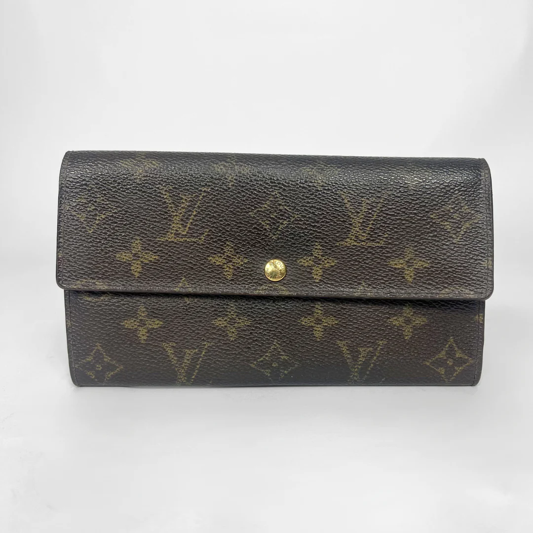 Louis Vuitton wallet with monogram pattern on a white background
