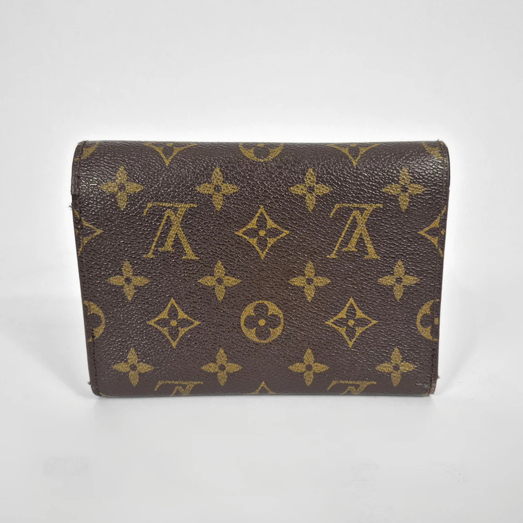 Louis Vuitton wallet with monogram pattern on a white background