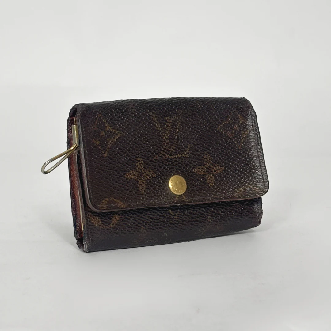 Brown wallet with gold accents on a light gray background