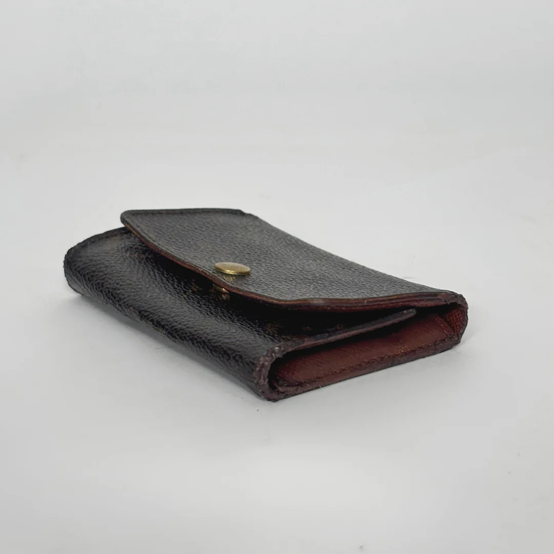 Black leather wallet on a light gray background