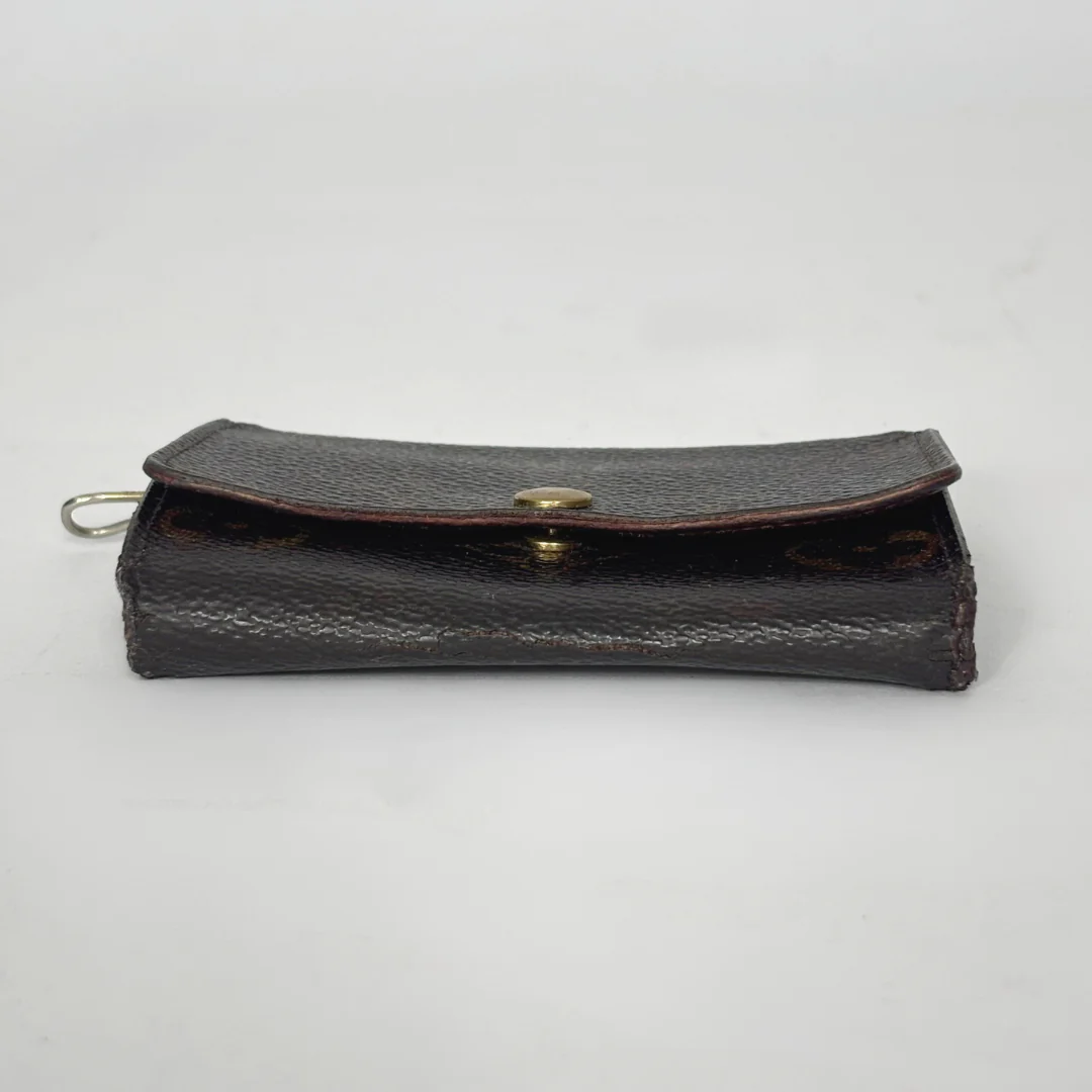 Black leather wallet with gold clasp on a white background