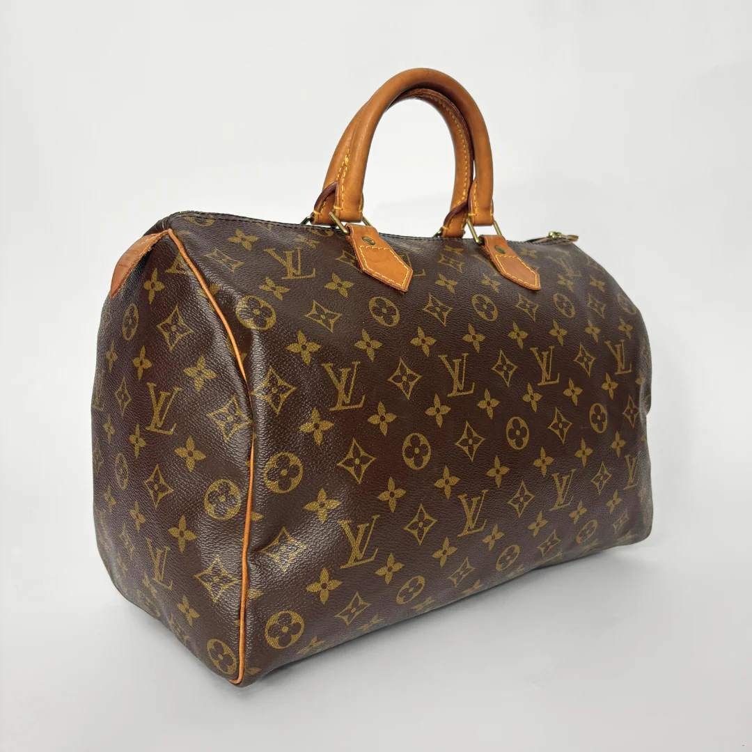 Brown handbag with monogram pattern on a white background