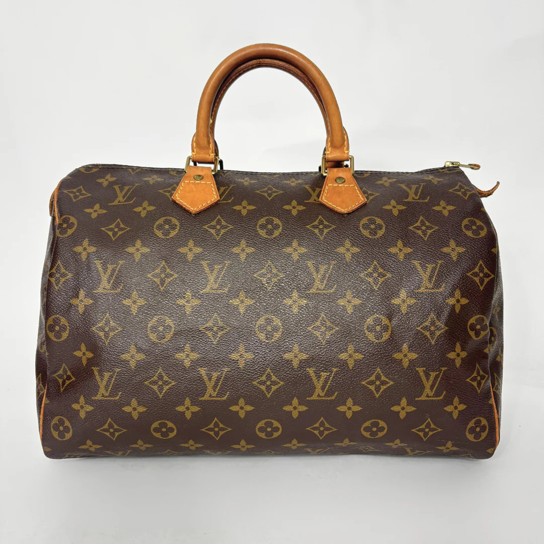 Brown handbag with monogram pattern on a white background
