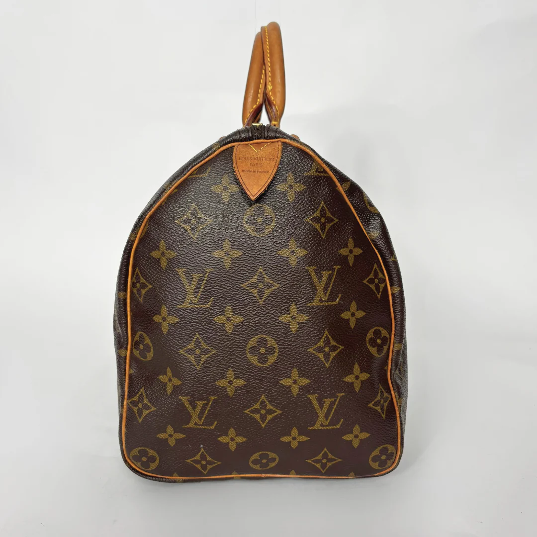 Brown handbag with monogram pattern on a white background