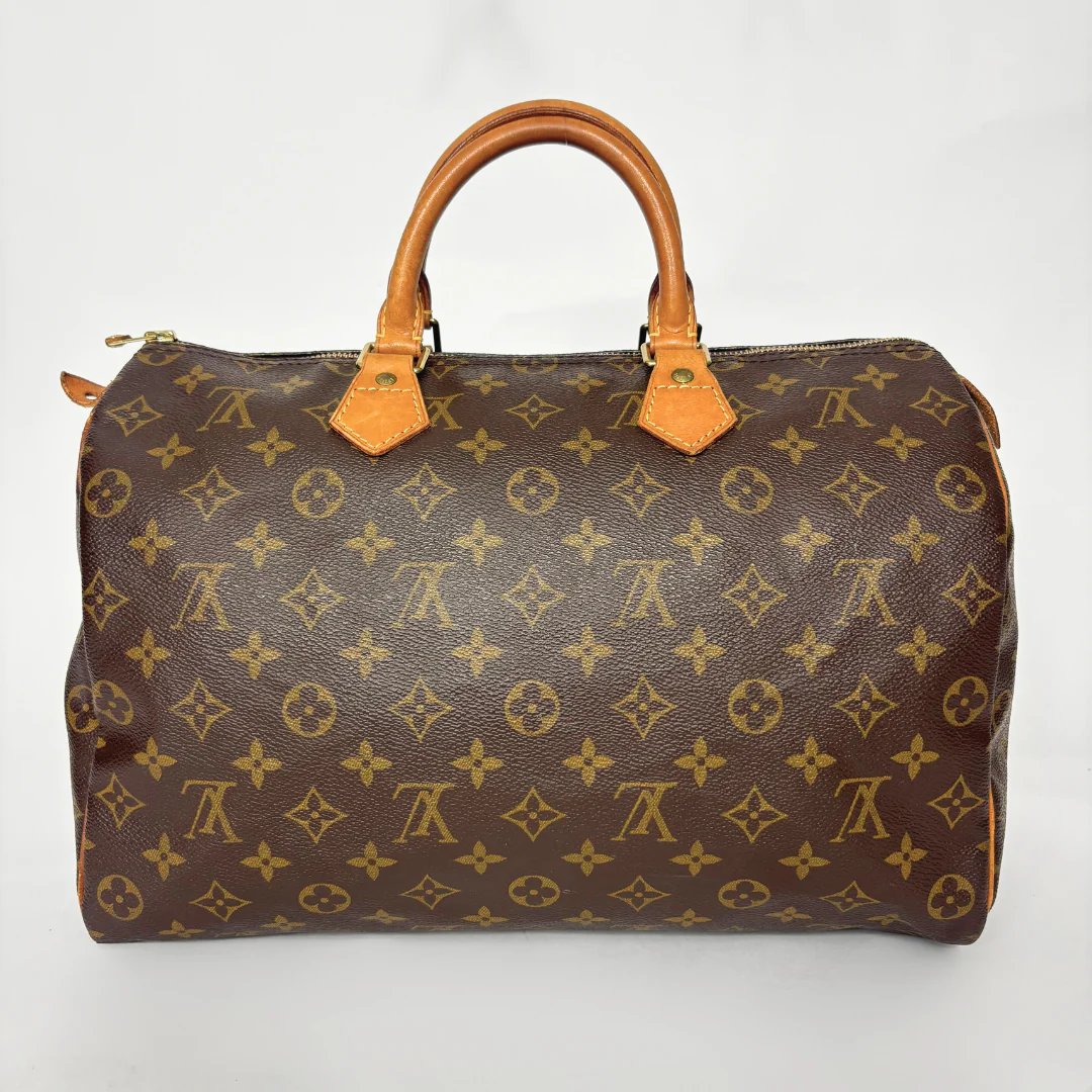 Brown handbag with monogram pattern on a white background