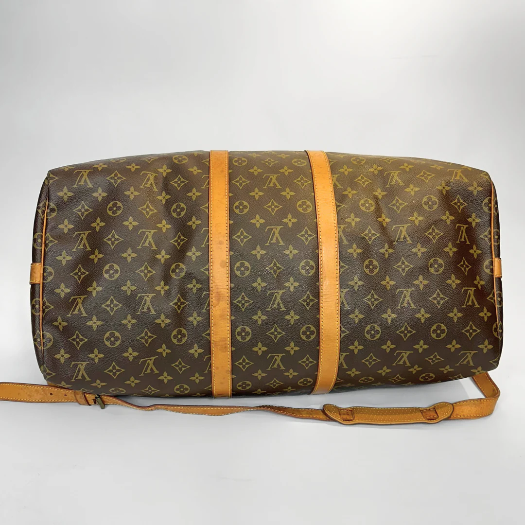 Brown duffel bag with monogram pattern on a white background