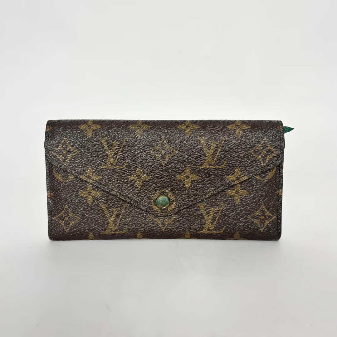 Designer wallet with monogram pattern on a white background