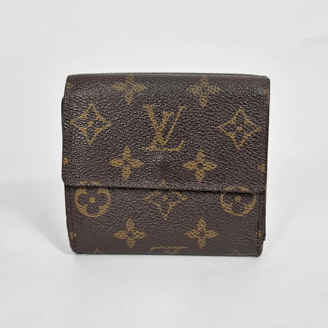Louis Vuitton wallet with monogram pattern on a light gray background