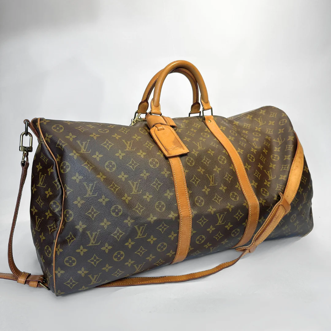 Louis Vuitton monogram duffel bag with brown straps on a white background