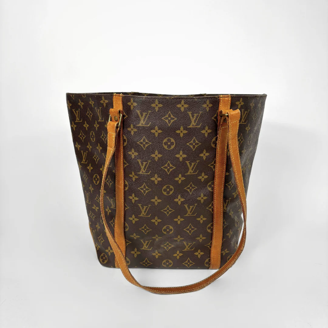 Designer handbag with monogram pattern on a white background