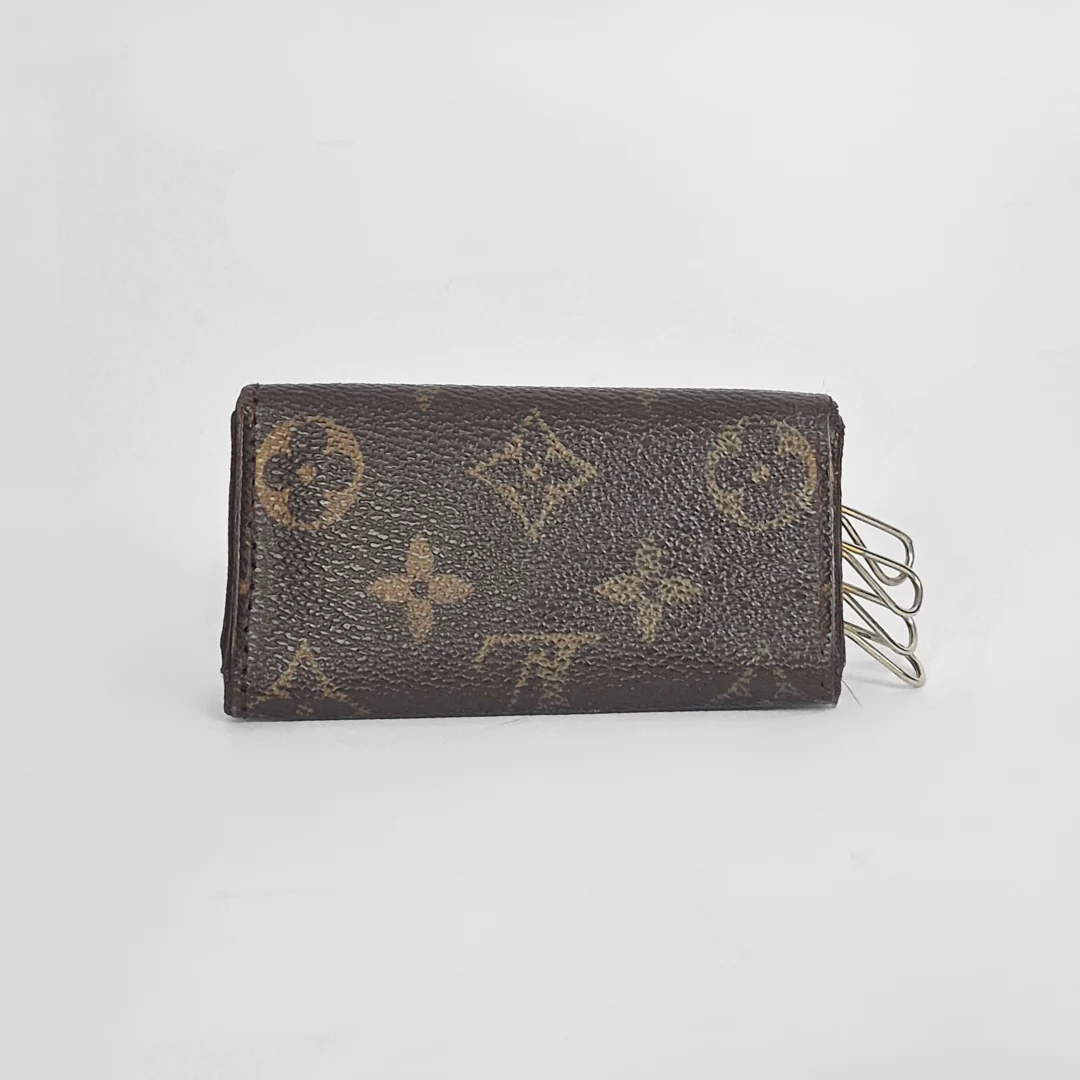 Brown wallet with monogram pattern on a light gray background