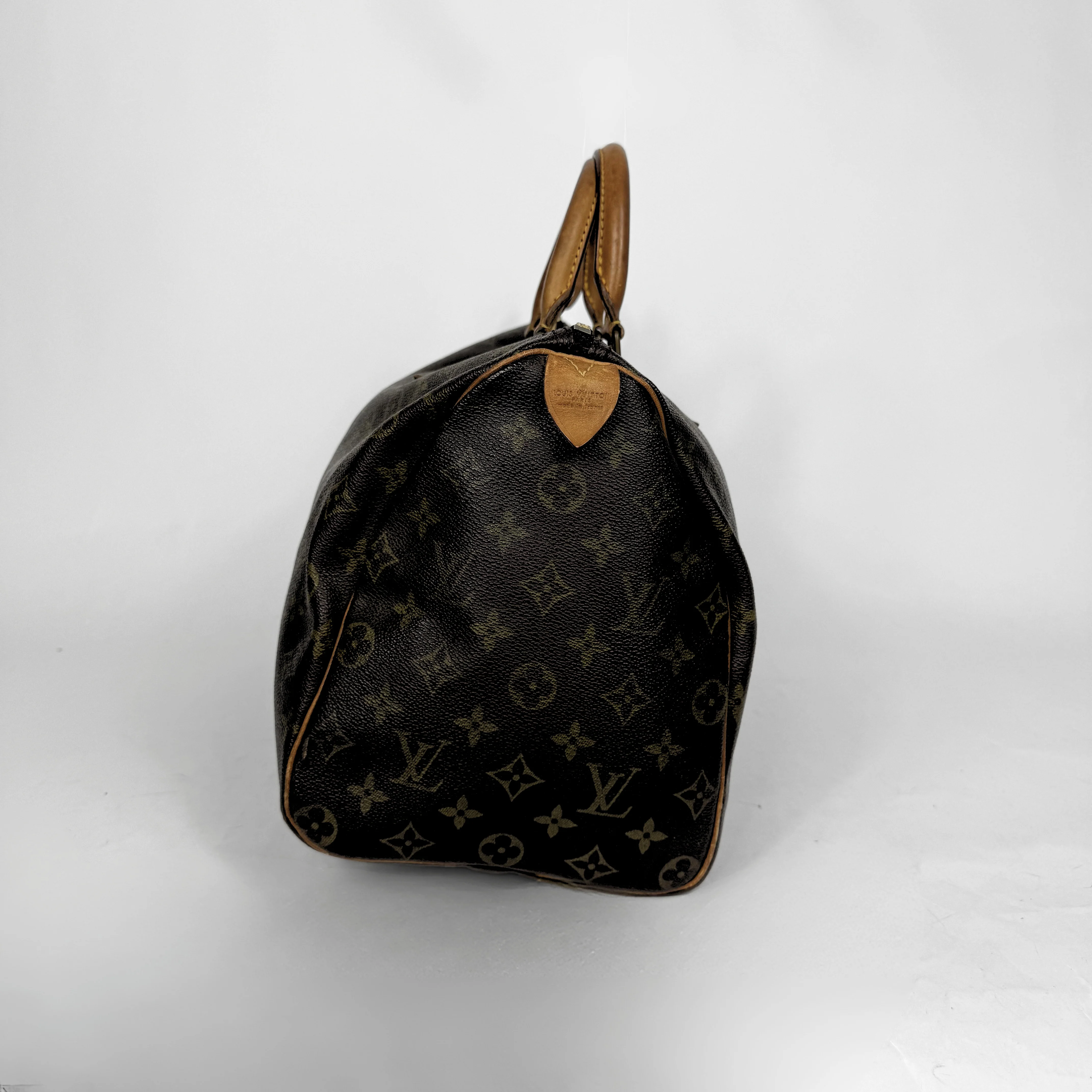 Designer handbag with monogram pattern on a white background