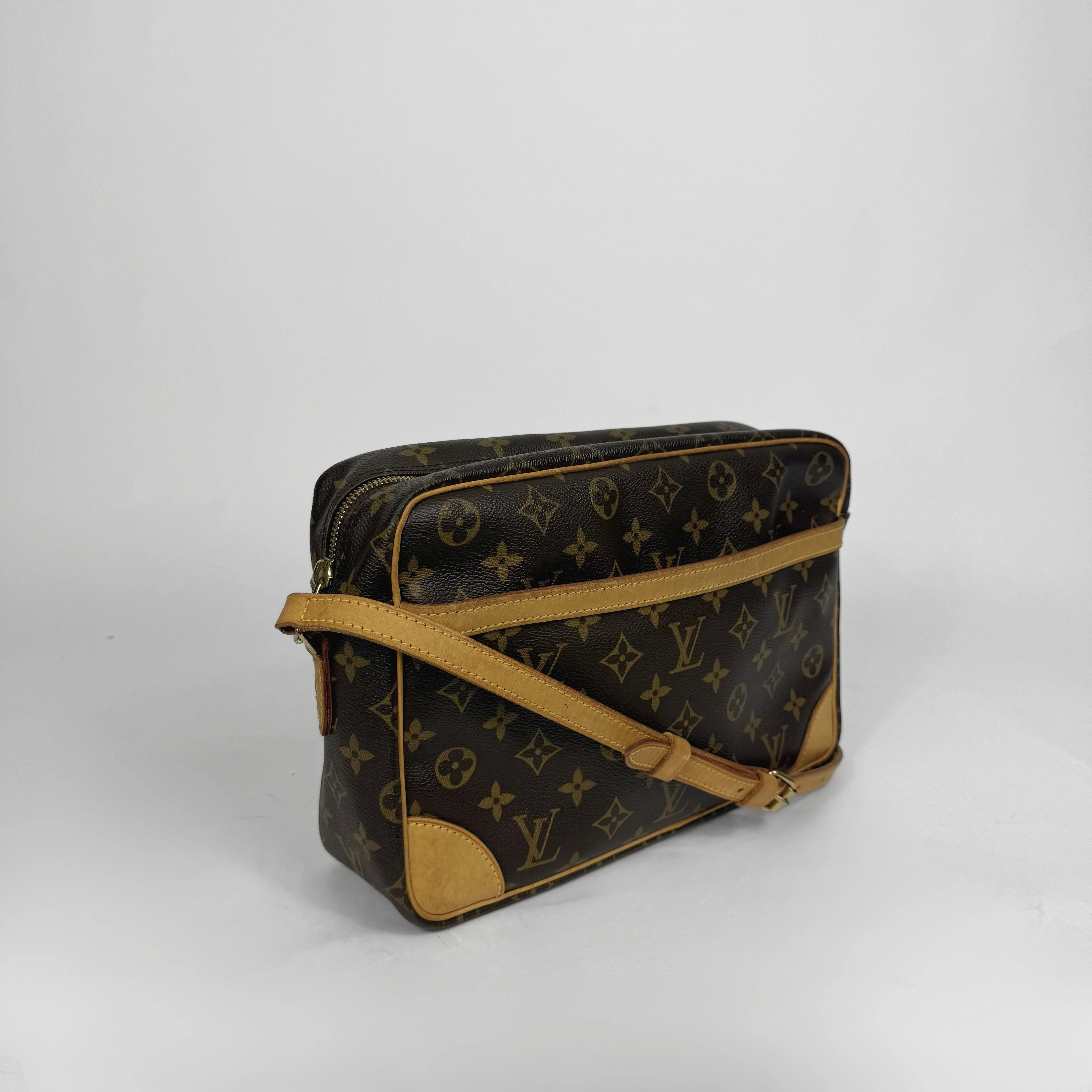 Brown handbag with gold monogram pattern 
