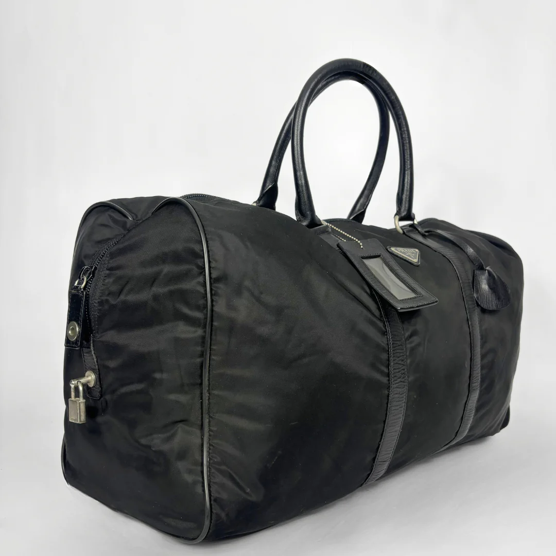Black backpack with a strap and lock on a white background
