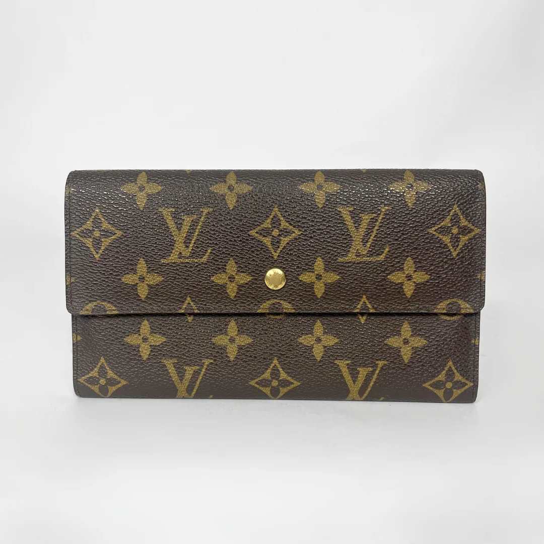 Louis Vuitton wallet with monogram pattern on a white background