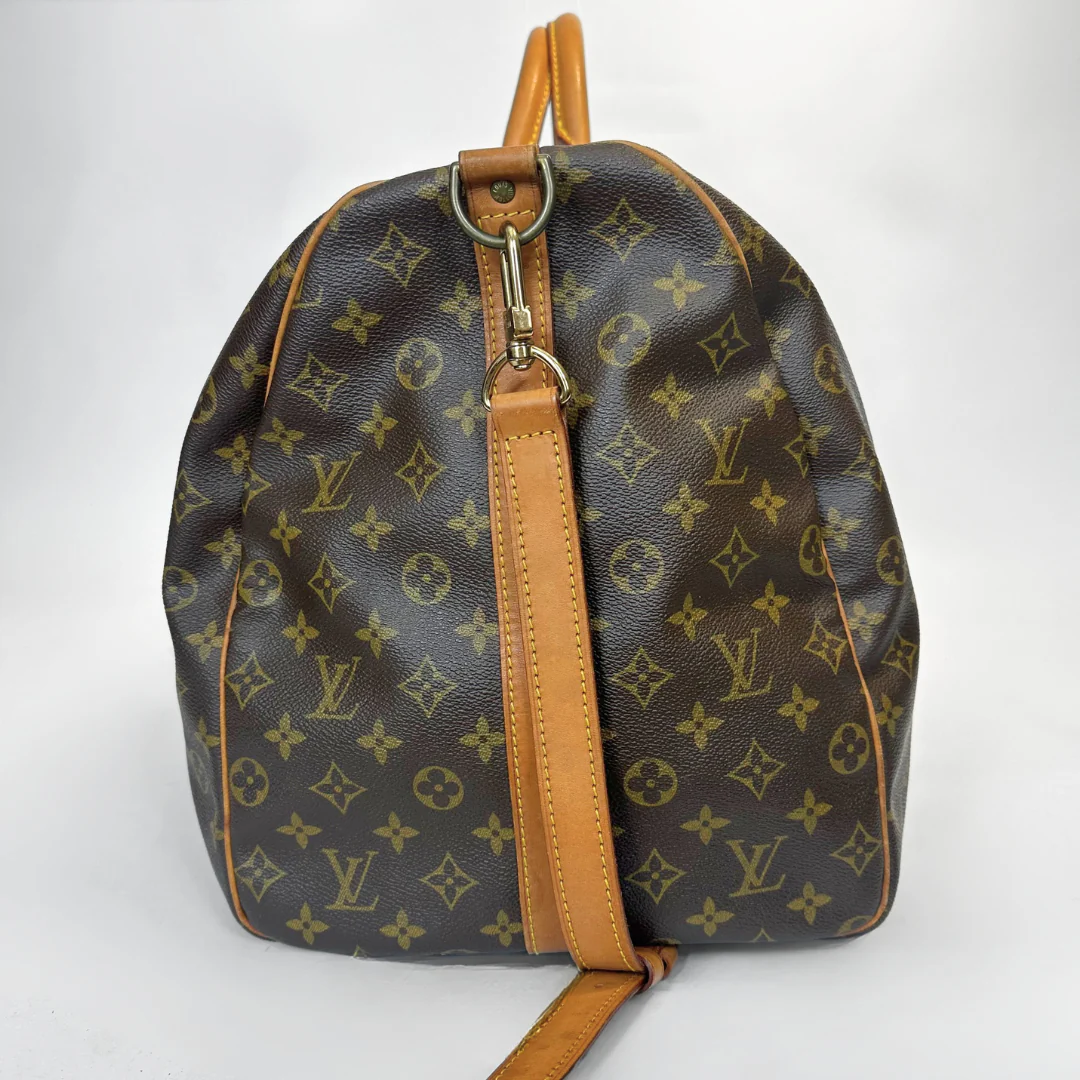 Brown backpack with tan leather straps on a white background