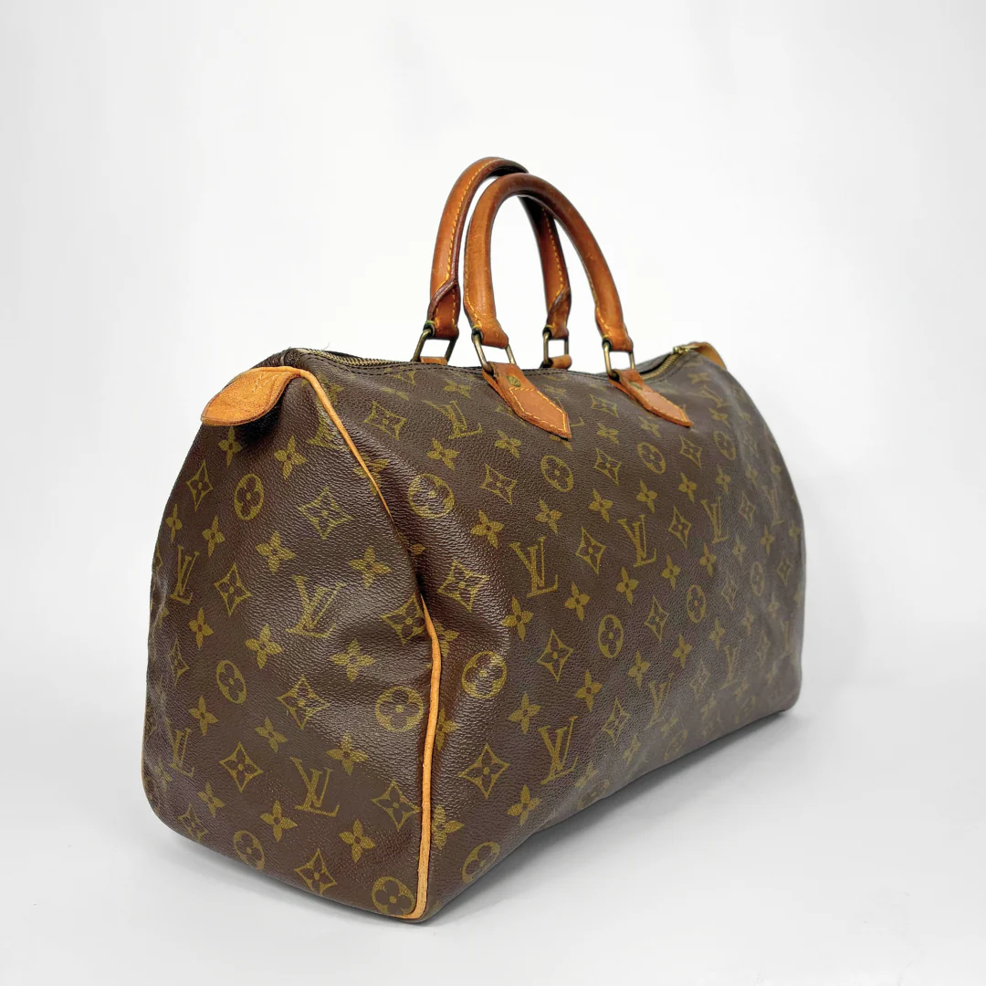 Brown handbag with monogram pattern on a white background