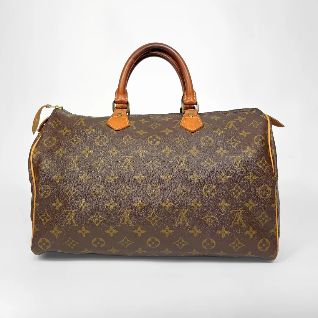 Brown handbag with monogram pattern on a white background