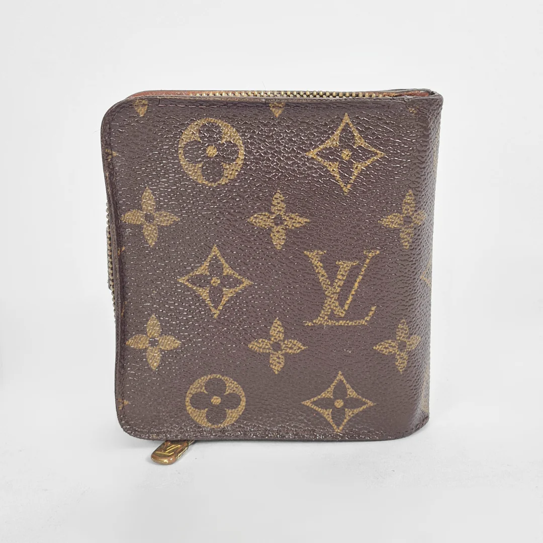 Louis Vuitton wallet with monogram pattern on a white background