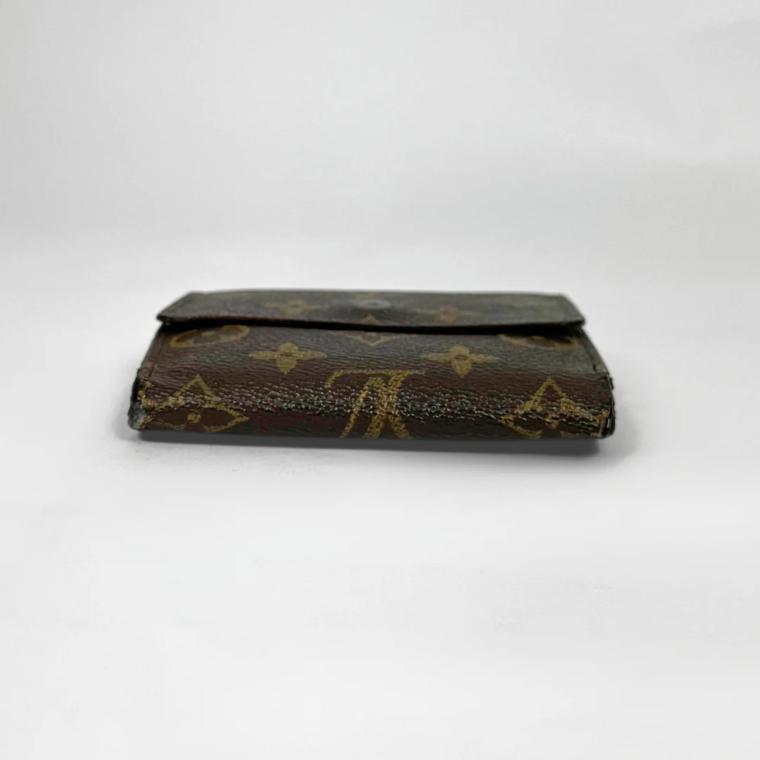 Vintage Louis Vuitton wallet with monogram pattern on a white background