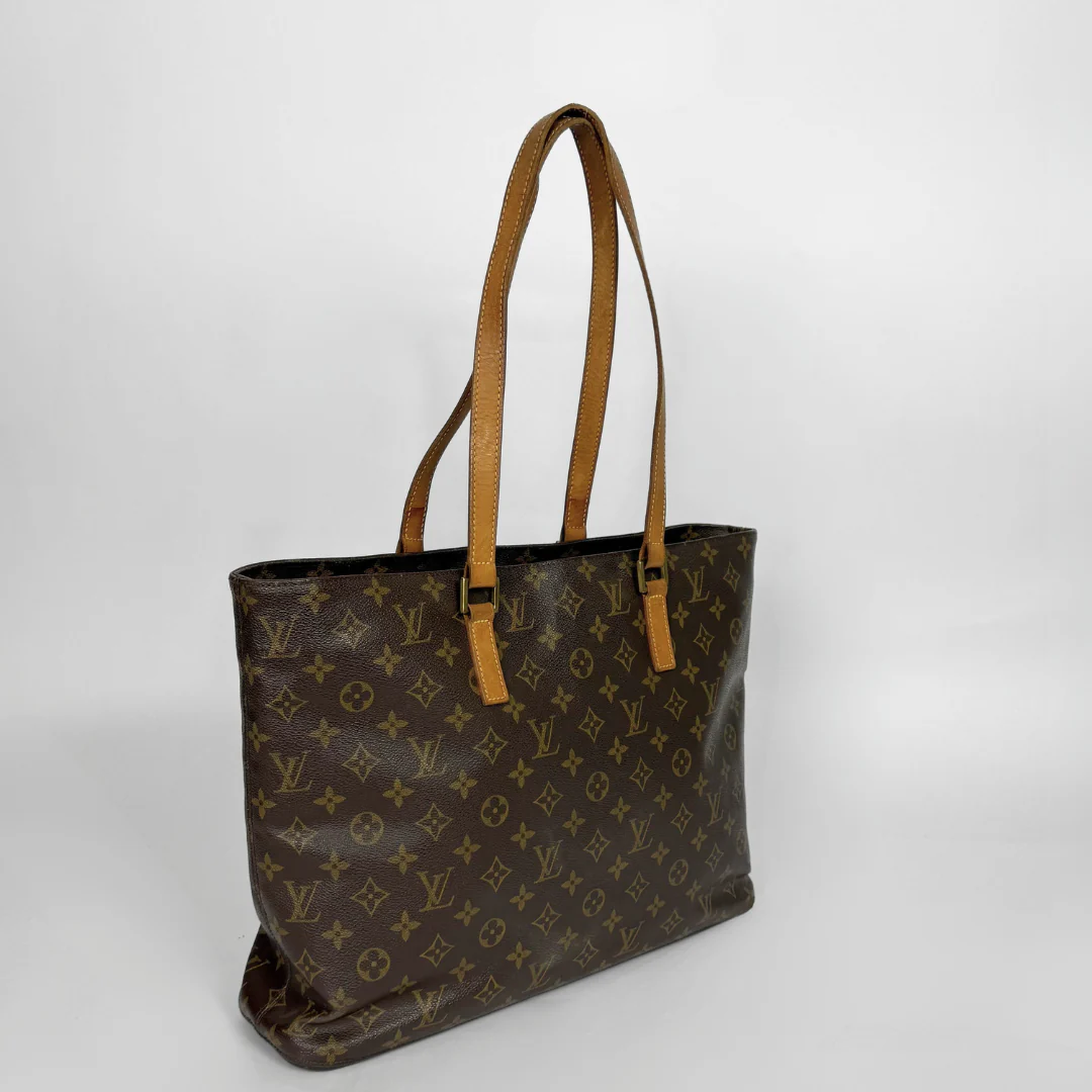Brown leather handbag with tan handles on a white background