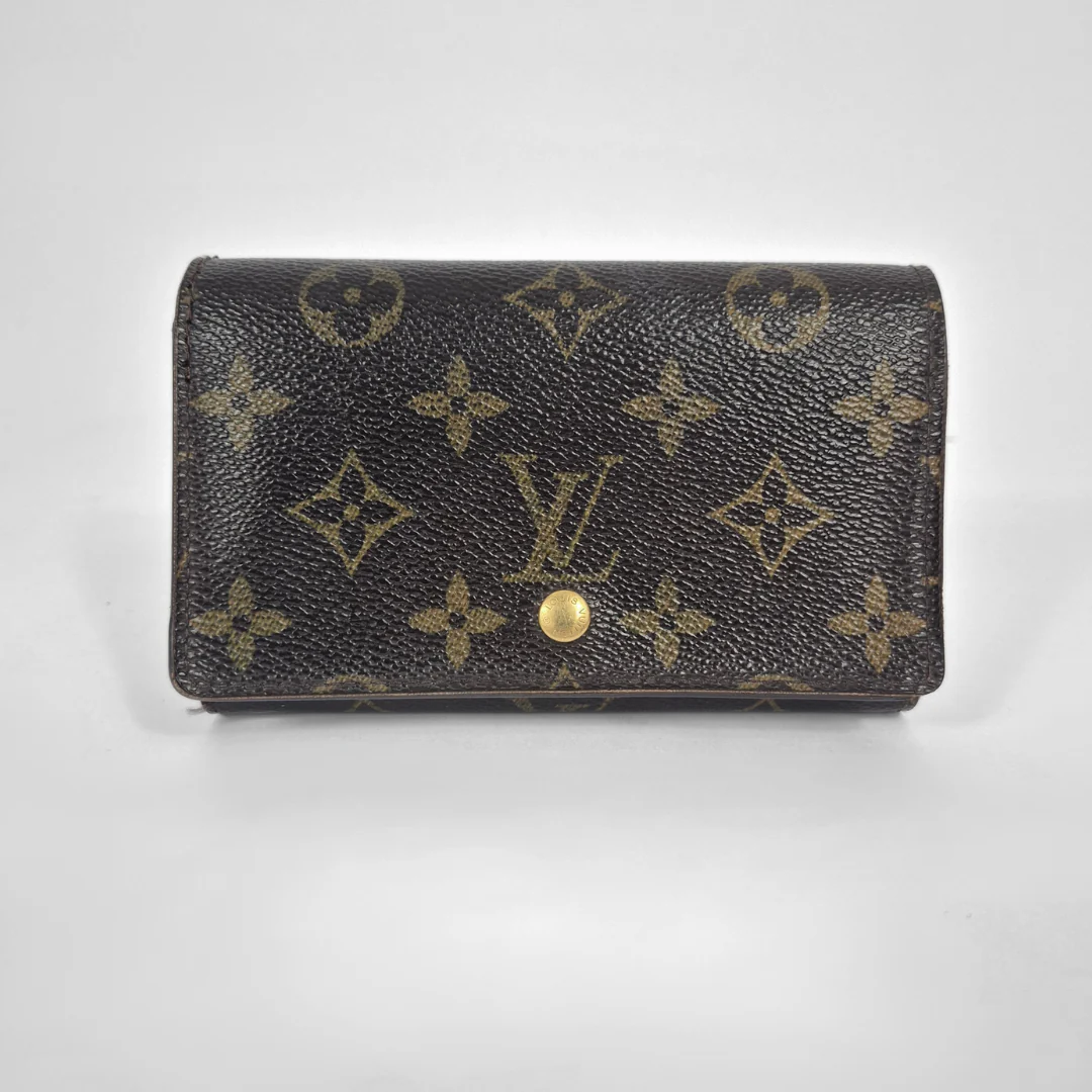 Louis Vuitton wallet with monogram pattern on a light gray background