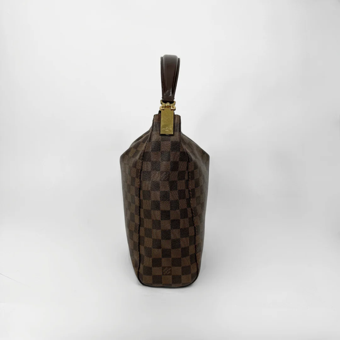 Brown checkered handbag with gold clasp on a white background